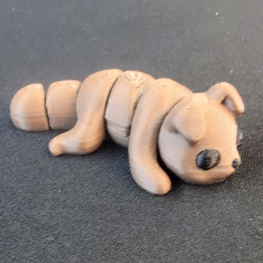 Articulated 3D-printed puppy with floppy ears and segmented body