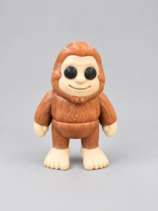 3D-printed Bigfoot figure in brown with cream face and feet