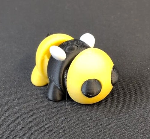 Small yellow-and-black 3D printed bumblebee toy