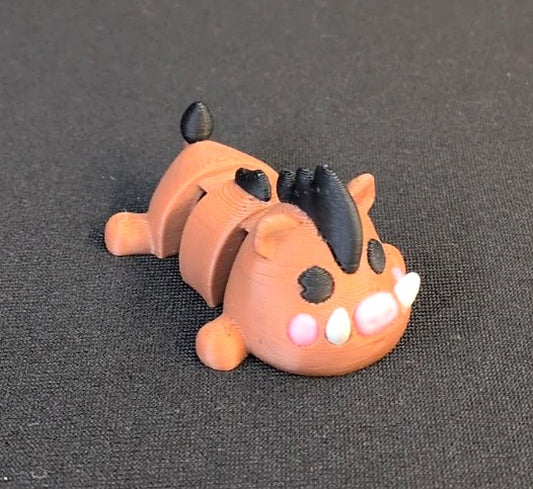 Articulated 3D printed warthog toy with orange body, black mane, pink snout, and white tusks